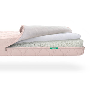 Cross-section view of a Newton Baby Crib Mattress showing its layered mesh and foam core construction. skip