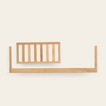 Light wooden baby crib side rail on a white background.
