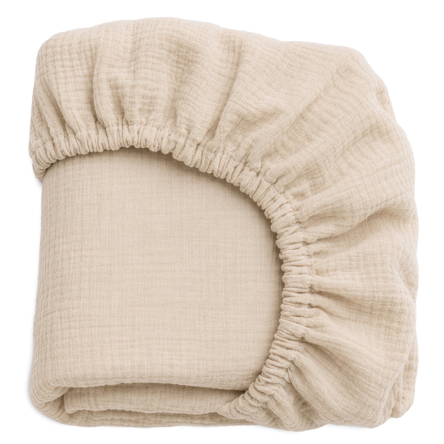 A beige, textured Newton Baby Nest Bassinet Extra Sheet—breathable and neatly folded—displays its elastic edge and gathered fabric at one corner.