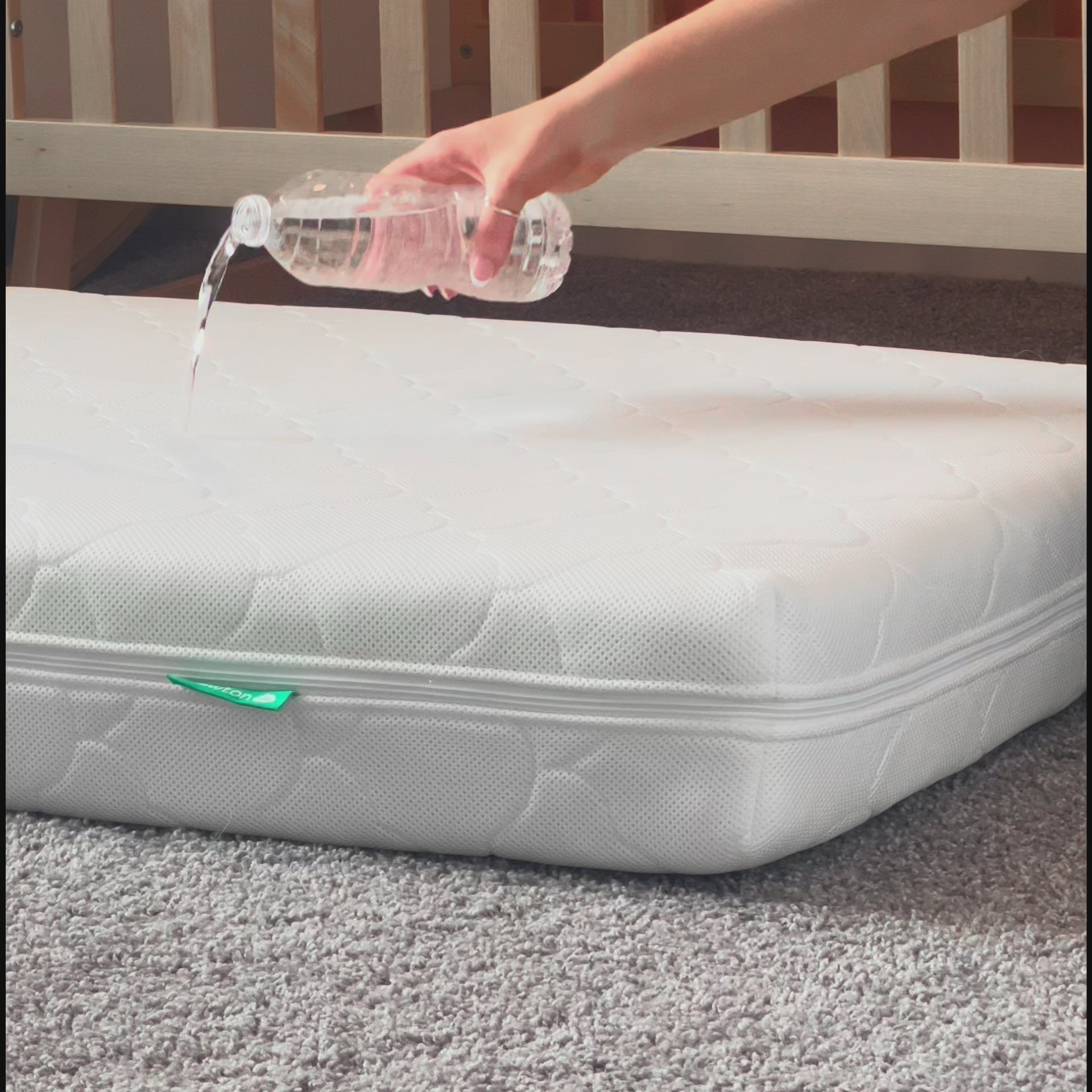 Vide of water being poured on newton waterproof mattress and not seeping through to core because of waterproof lining. 999-1000-WHT-ST