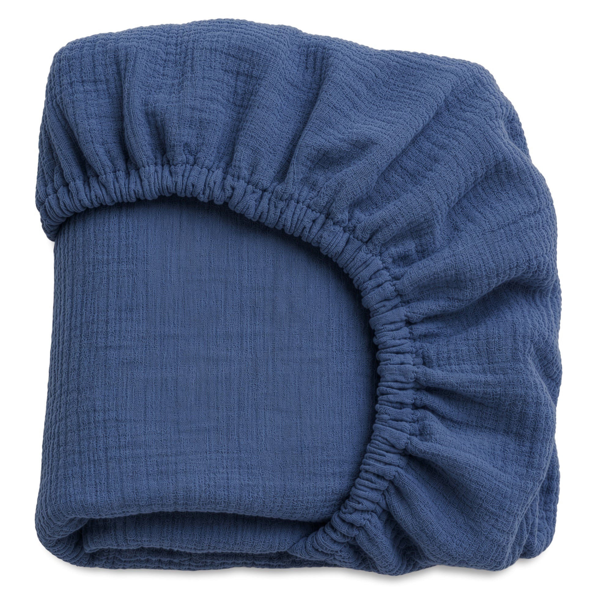A neatly folded dark blue Breathable, Organic Cotton Sheet from Newton Baby (2-pack), featuring an elastic edge, displayed against a white background.