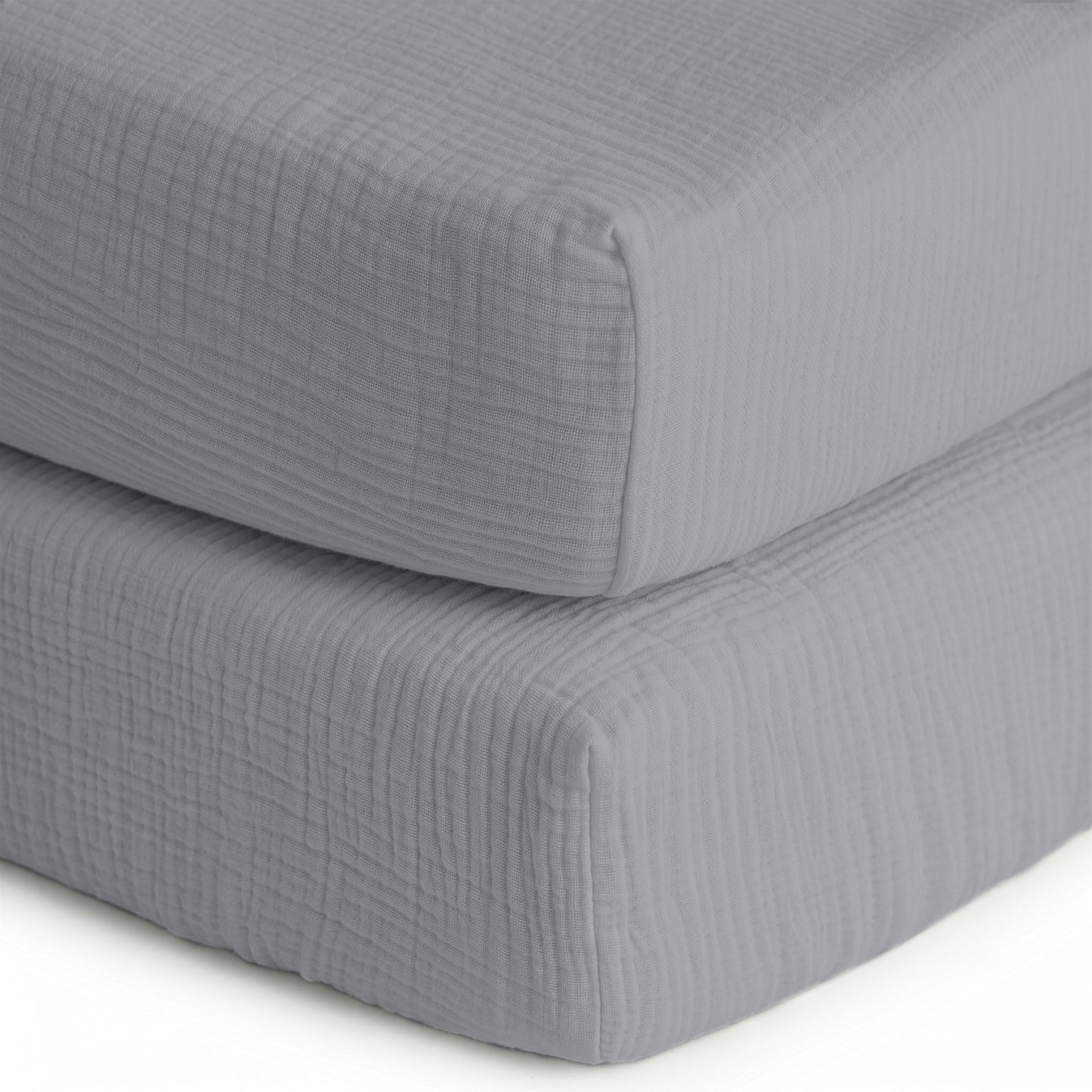 Two neatly stacked, light gray quilted cushions are shown on a white background—perfect as a base for Newton Baby’s Breathable, Organic Cotton Sheets (2-pack).