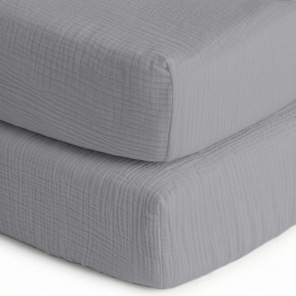 Two neatly stacked, light gray quilted cushions are shown on a white background—perfect as a base for Newton Baby’s Breathable, Organic Cotton Sheets (2-pack).