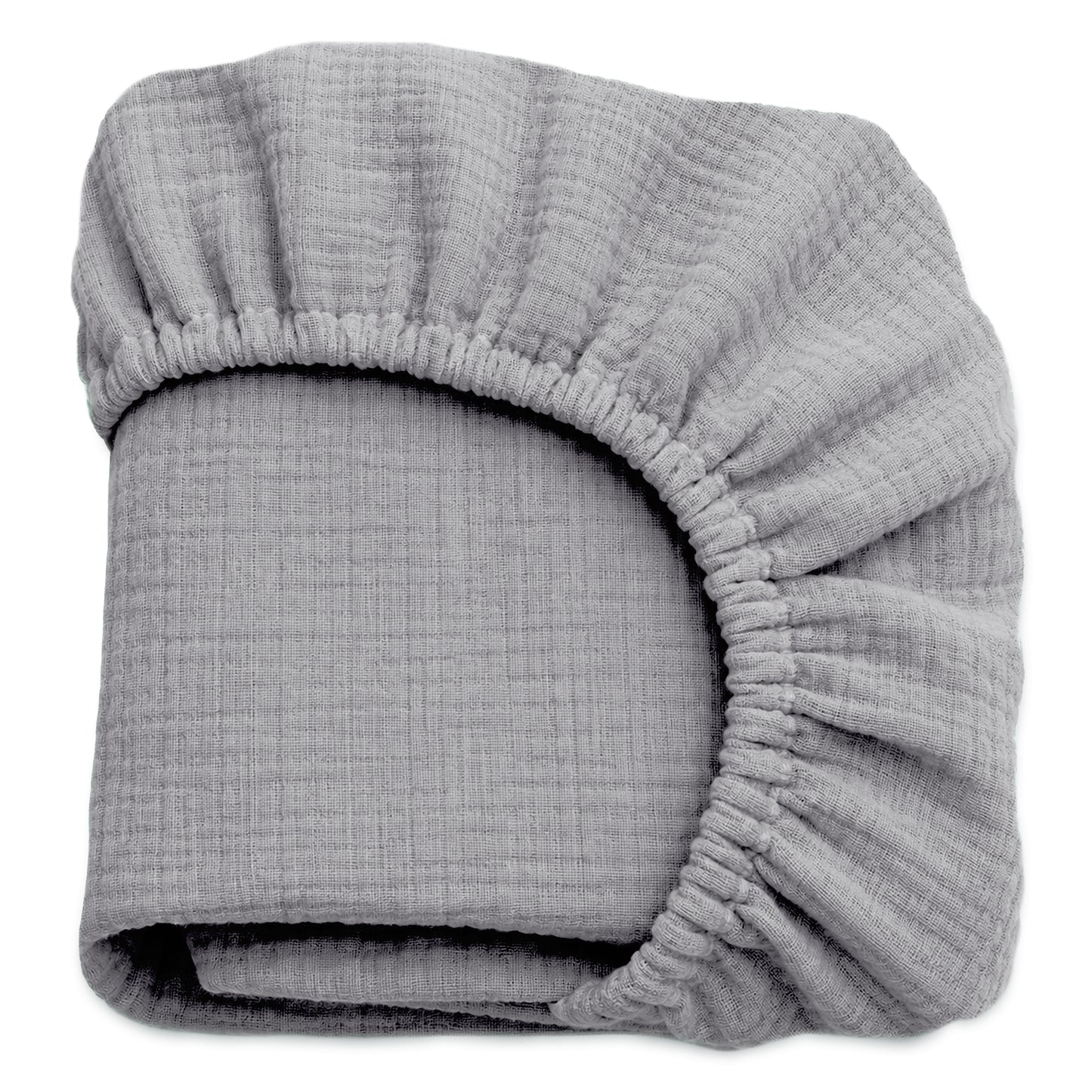 A folded, light gray Newton Baby Breathable, Organic Cotton Sheet (2-pack), made from crinkled muslin with elastic edges, is shown against a white background. 999-3020-EVG
