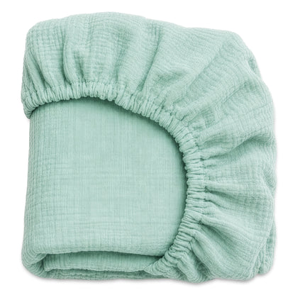 Newton Baby’s Breathable, Organic Cotton Sheets (2-pack) offer soft, hypoallergenic crib sheets in mint green with a textured finish—ideal for parents seeking comfort and quality for their baby.