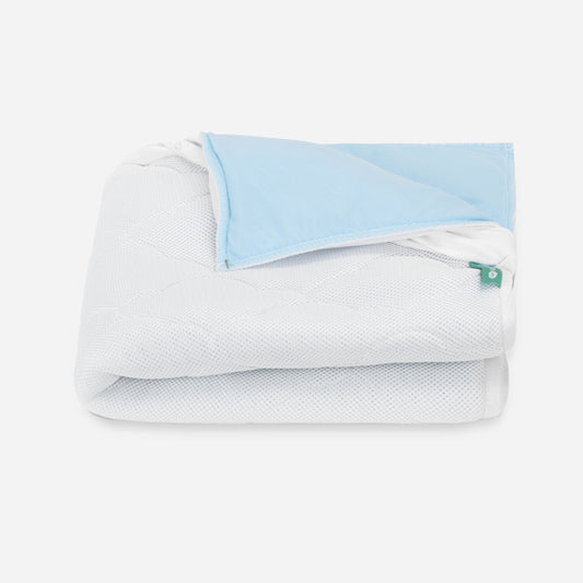 Folded baby waterproof mattress pad from Newton Baby, showcasing breathable fabric design. skip