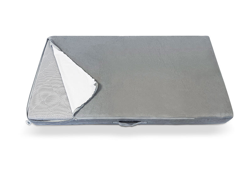 A figgy couch piece with a removable gray cover partially peeled back to reveal the inner material.