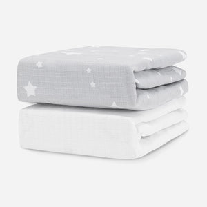 Stack of two baby mattresses with a star-patterned cover on the top mattress. skip