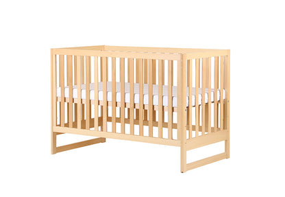 Natural wood baby crib with a white mattress, isolated on a white background.